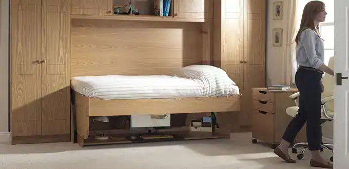 A compact, adjustable study bed designed for small rooms, featuring a wooden frame and integrated storage, ideal for efficient space utilisation in student dormitories or bedrooms.